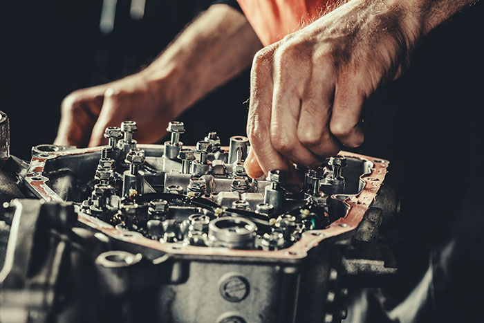 closeup of mechanic fixing continuously variable transmission gearbox