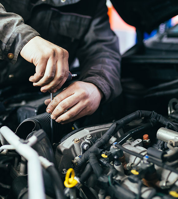 close-up of a mechanic's hands working on car